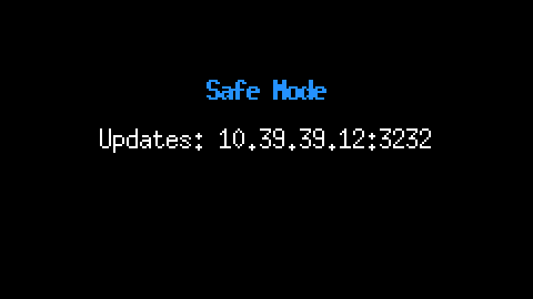 The Cardputer screen at 2x, black, with Safe Mode in blue in the middle and, under it, Updates: 10.39.39.12:3232