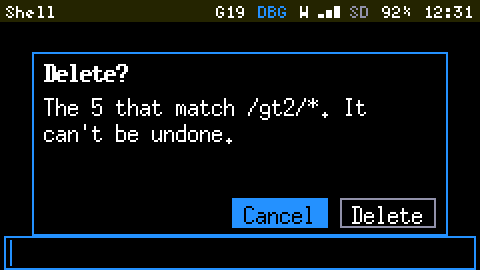 The Cardputer's screen at 2x: a dialog titled Delete? reading The 5 that match /gt2/*. It can't be undone. with two buttons, Cancel selected and Delete.